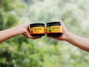 People holding jars of Re-Lyte Immunity for clean, no-sugar energy support