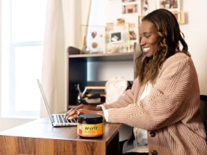 Woman working on laptop with Re-Lyte Energy for clean, no sugar hydration and energy support.