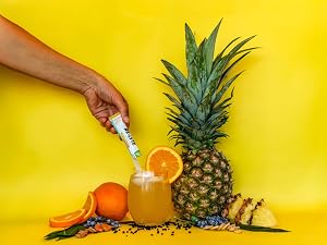 A person pouring Re-Lyte Immunity in a glass for clean, no sugar immune support.