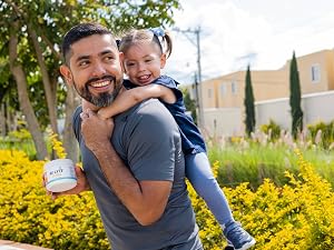 A man with his child and Re-Lyte Immunity for clean, no-sugar hydration and immune support.